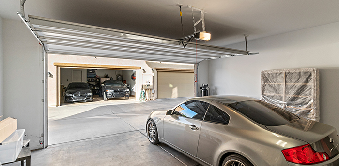 Interior view of an open garage with a car inside.