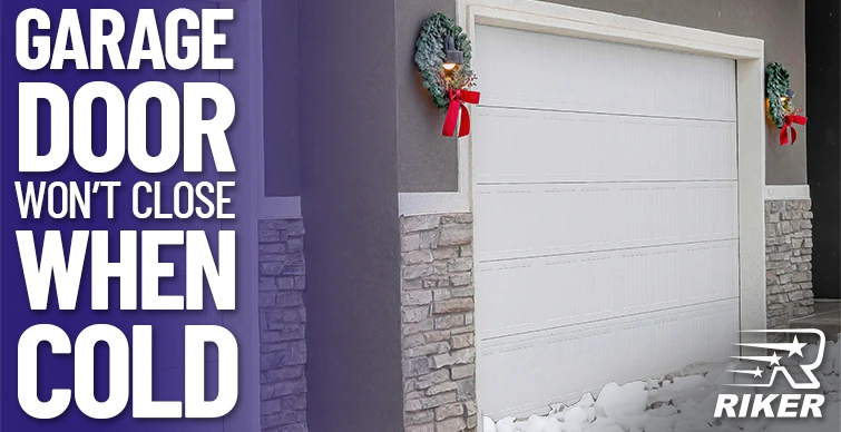 Garage door partially open with snow on the ground and holiday wreath decorations on each side, with text reading 'Garage Door Won't Close When Cold.'