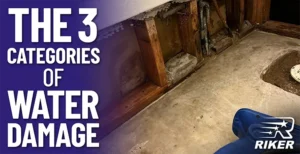 Exposed structural wood and concrete in a water-damaged area, with the text 'The 3 Categories of Water Damage' on a purple background.